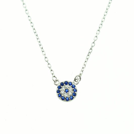 A small round silver necklace with a blue and white patterned design, likely representing an evil eye, attached to a silver chain.